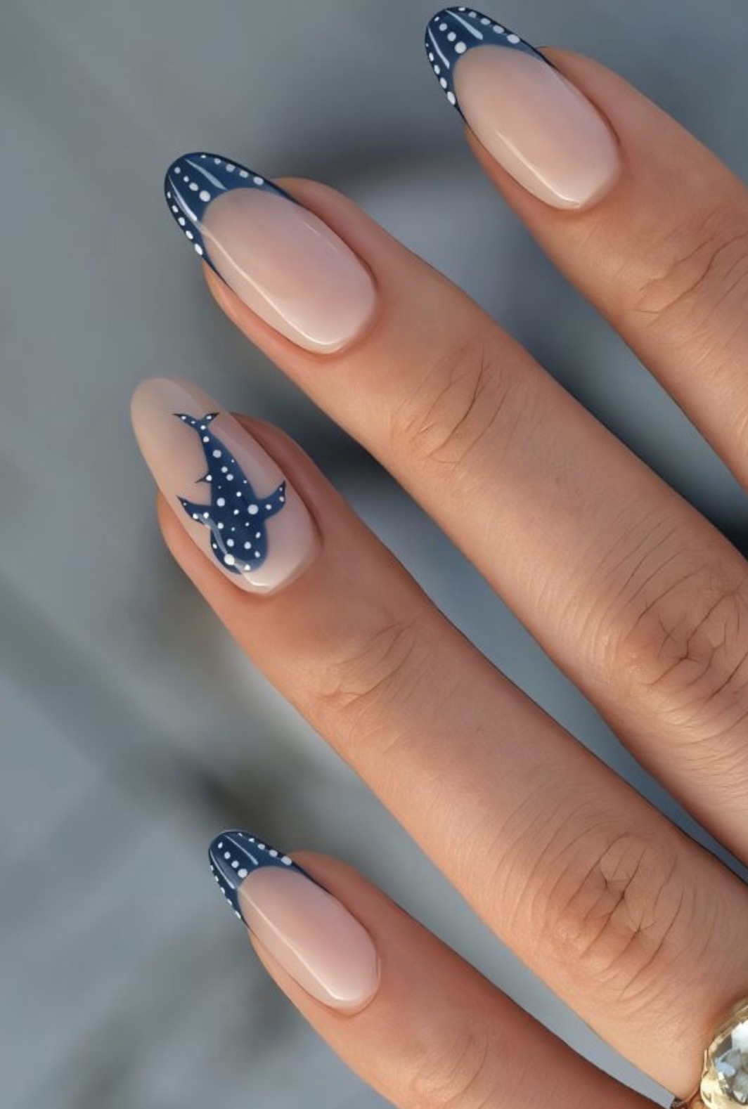 Navy and nude nail art with playful whale shark detail
