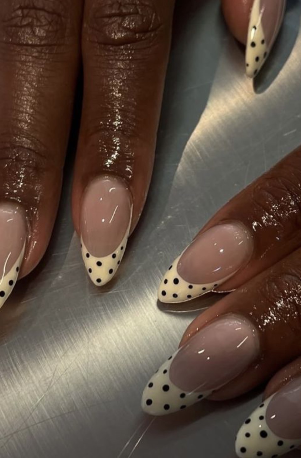 Black dotted French tips on almond nails