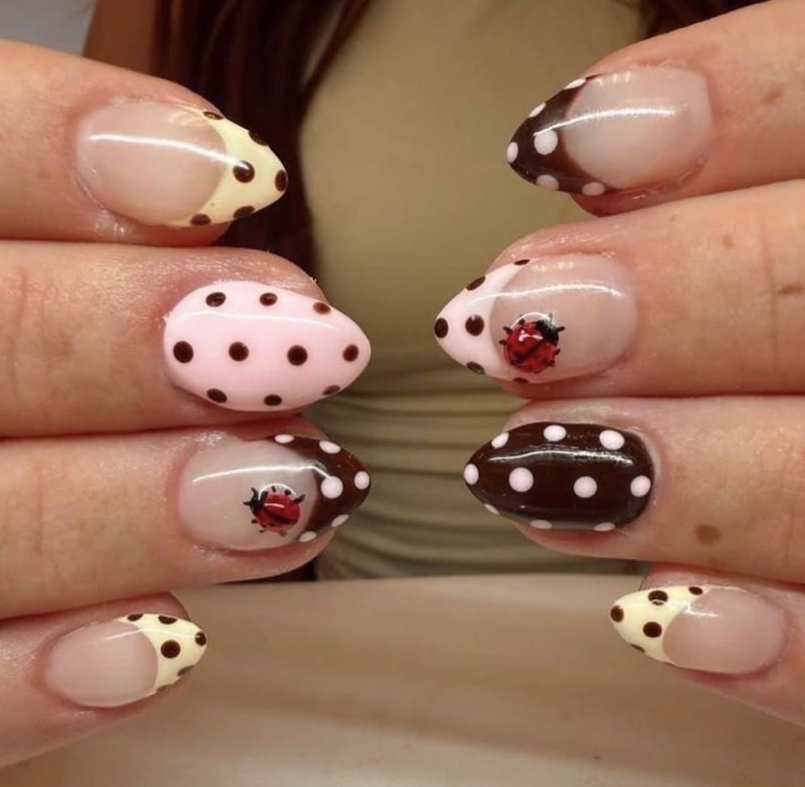 Polka dot ladybug nail art with brown, cream and pink